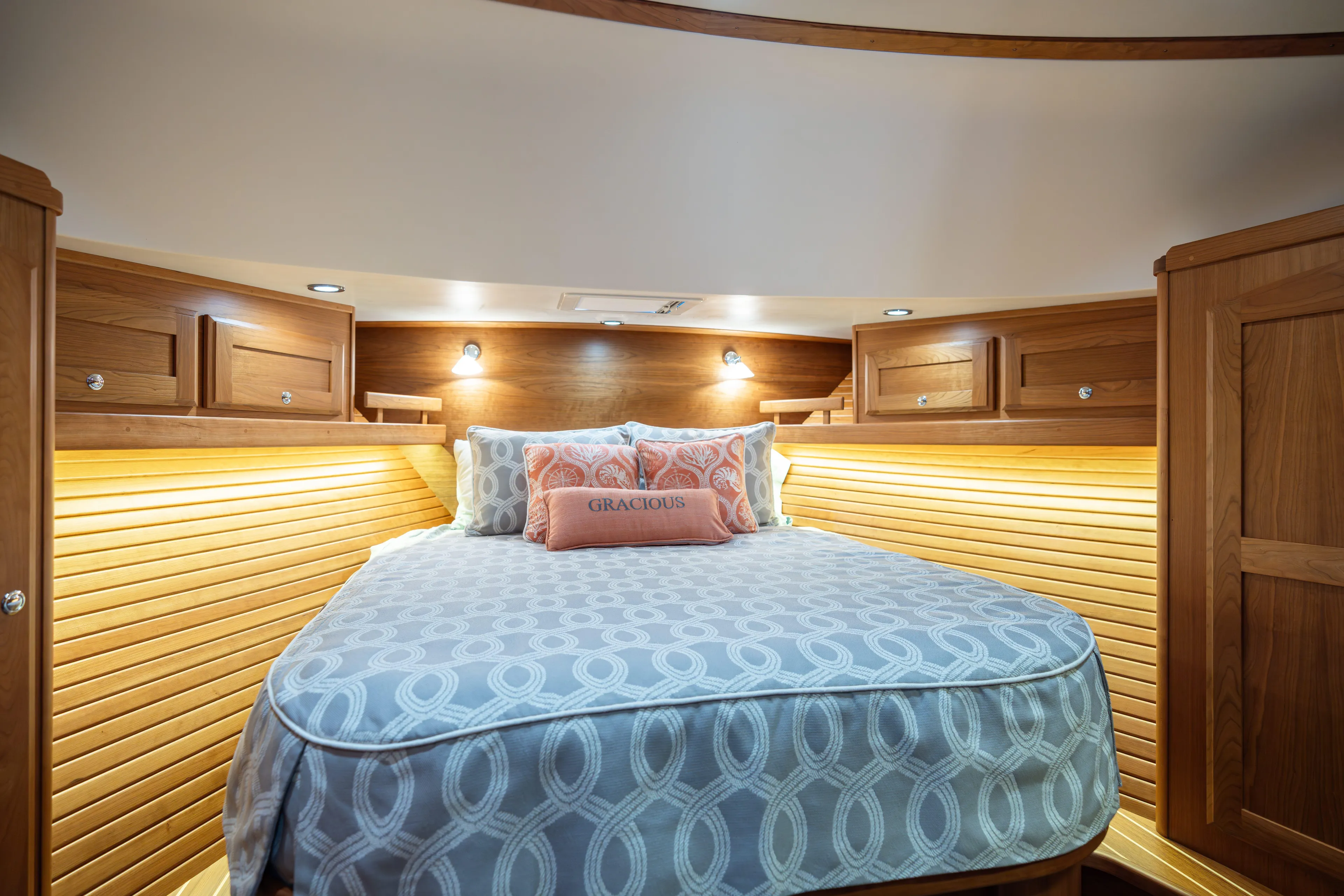 Gracious Yacht Photos Pics Luxurious cabin interior of 2020 Sabre 48 Salon Express yacht with cozy bed and wooden accents.