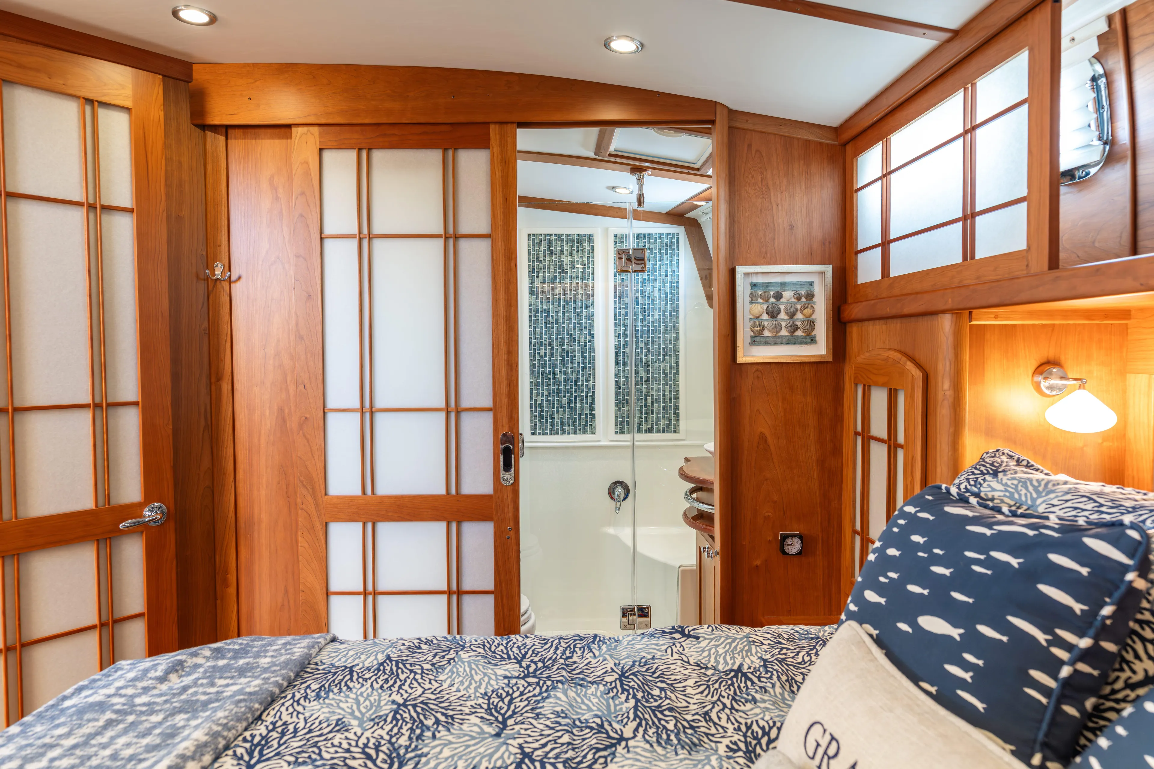 Gracious Yacht Photos Pics Interior of 2020 Sabre 48 Salon Express with wooden accents and cozy bedding.
