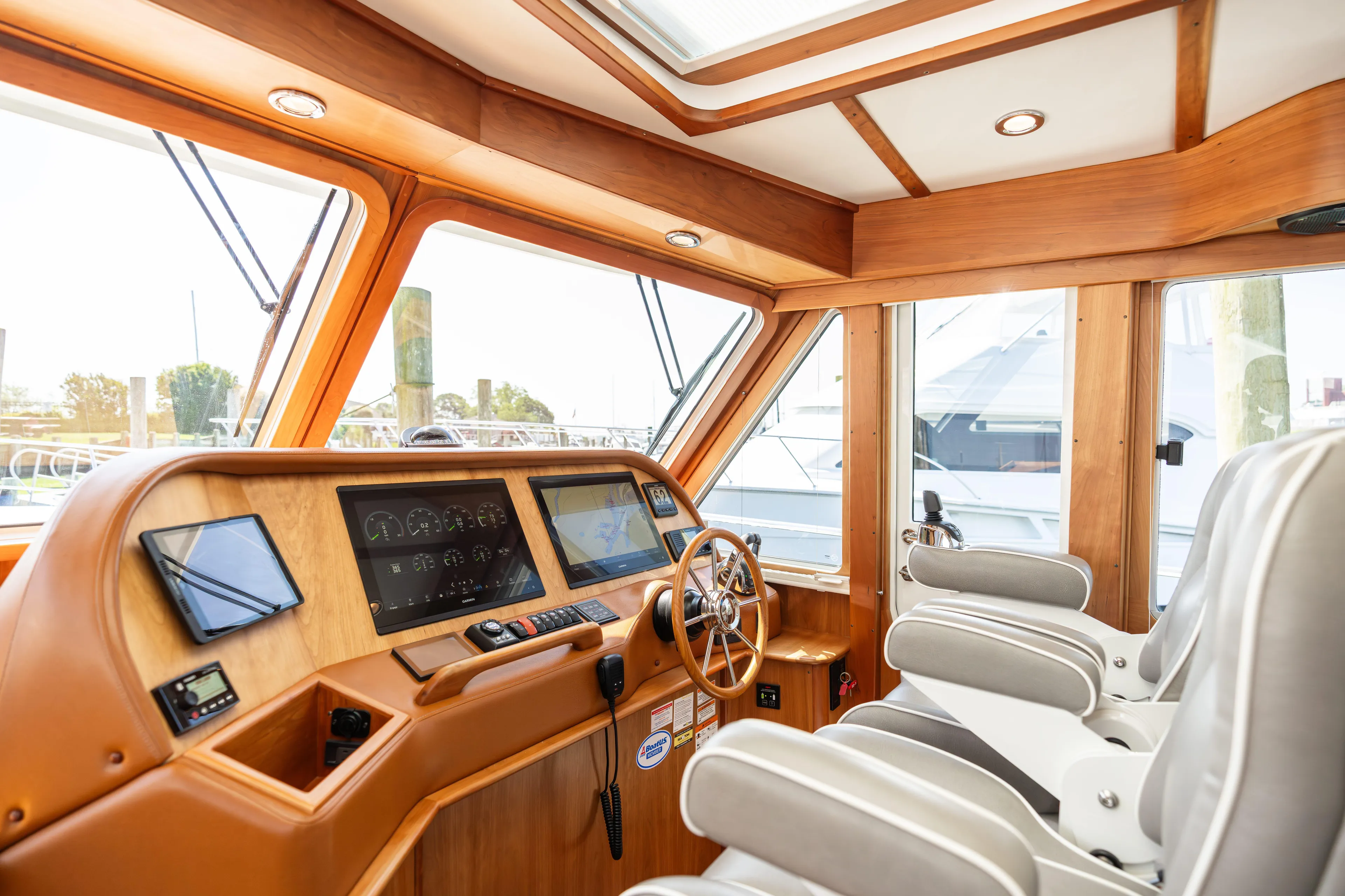 Gracious Yacht Photos Pics Interior of 2020 Sabre 48 Salon Express yacht with modern helm and luxurious seating.