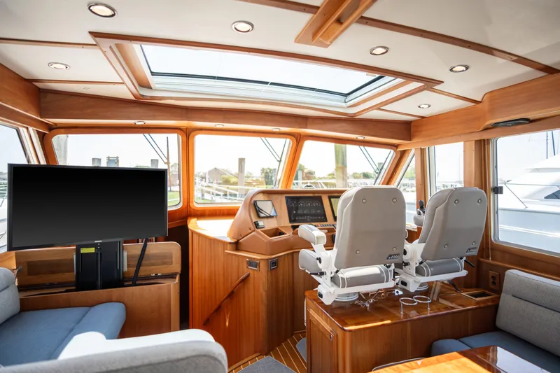 Gracious Yacht Photos Pics 2020 Sabre 48 Salon Express interior with helm, seating, and large windows.