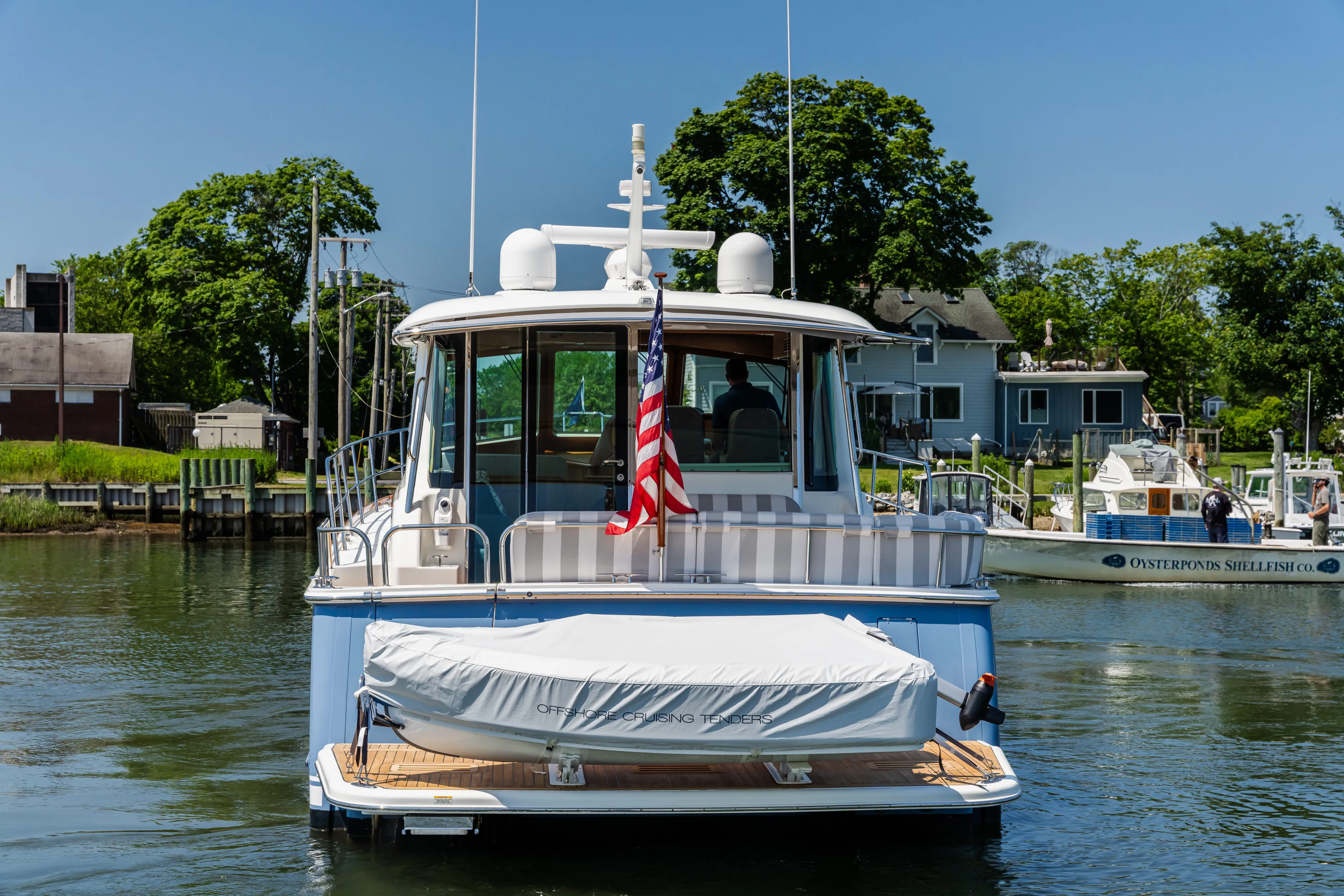 Gracious Yacht Photos Pics 2020 Sabre 48 Salon Express yacht docked with American flag, sunny day.