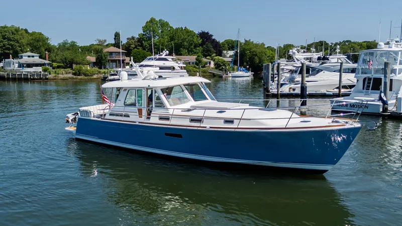 Gracious Yacht Photos Pics 2020 Sabre 48 Salon Express yacht docked in a serene marina setting.