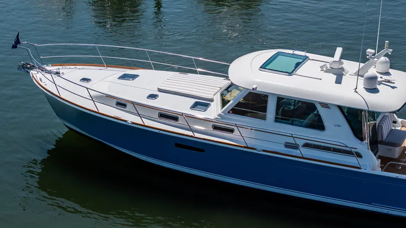 Gracious Yacht Photos Pics 2020 Sabre 48 Salon Express yacht on calm water, showcasing sleek design and luxury features.