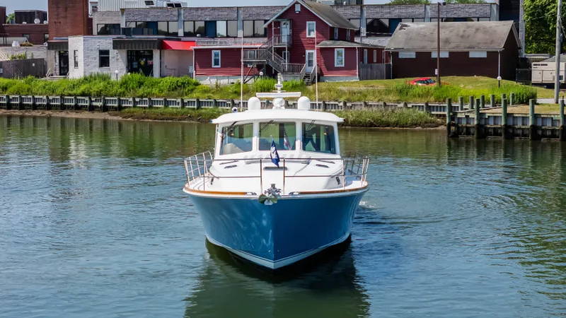 Gracious Yacht Photos Pics 2020 Sabre 48 Salon Express yacht cruising in a calm harbor.