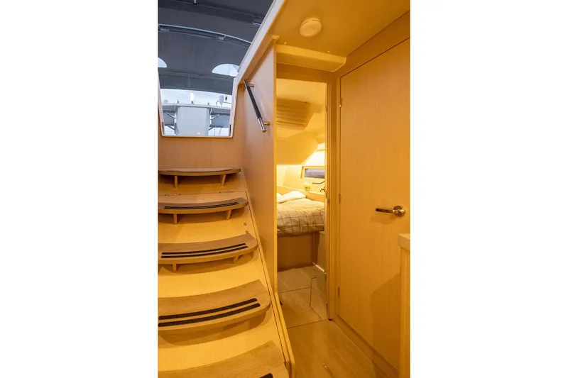  Yacht Photos Pics Interior view of 2021 Beneteau Oceanis 46.1 yacht cabin with wooden stairs.