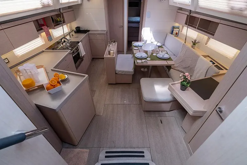  Yacht Photos Pics Luxurious interior of 2021 Beneteau Oceanis 46.1 yacht with modern kitchen and dining area.