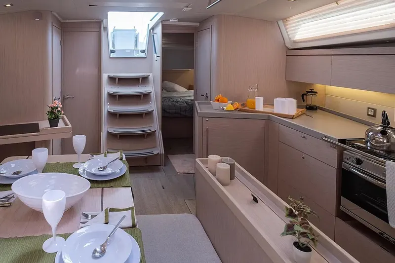  Yacht Photos Pics Luxurious interior of 2021 Beneteau Oceanis 46.1 yacht with modern kitchen and dining area.