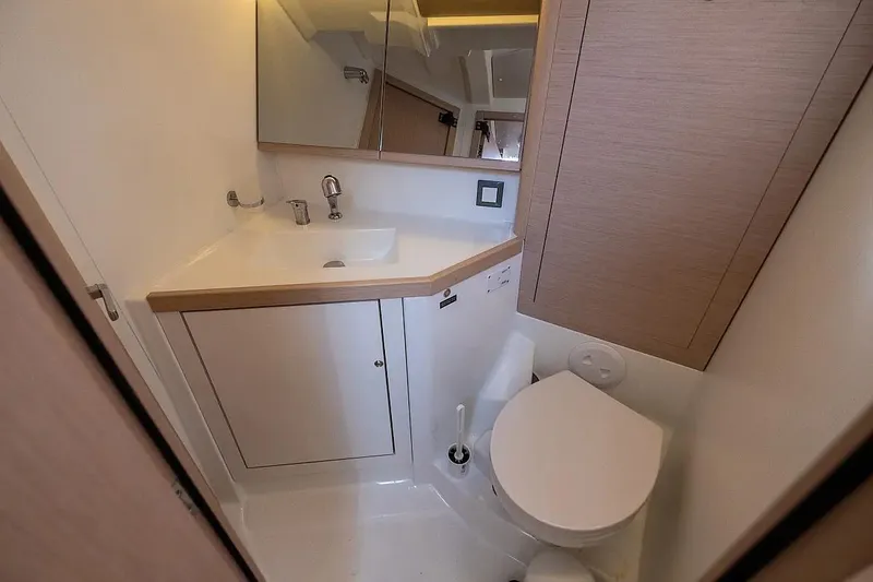  Yacht Photos Pics Bathroom interior of 2021 Beneteau Oceanis 46.1 yacht, featuring sink and toilet.