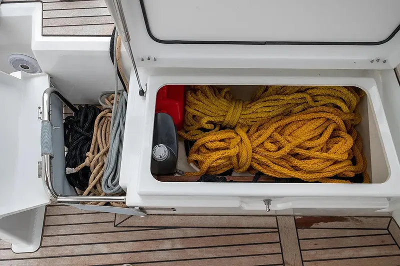  Yacht Photos Pics Storage compartment with ropes on a 2021 Beneteau Oceanis 46.1 yacht deck.