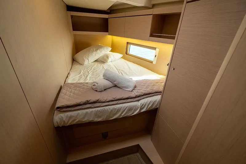  Yacht Photos Pics Cozy cabin interior of 2021 Beneteau Oceanis 46.1 yacht with bed and window.