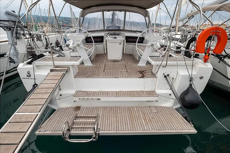  Yacht Photos Pics 2021 Beneteau Oceanis 46.1 yacht with dual steering wheels and teak deck in marina.