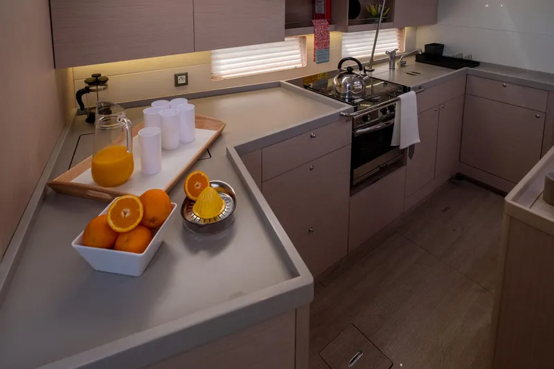  Yacht Photos Pics Modern kitchen in 2021 Beneteau Oceanis 46.1 yacht with oranges and juice setup.