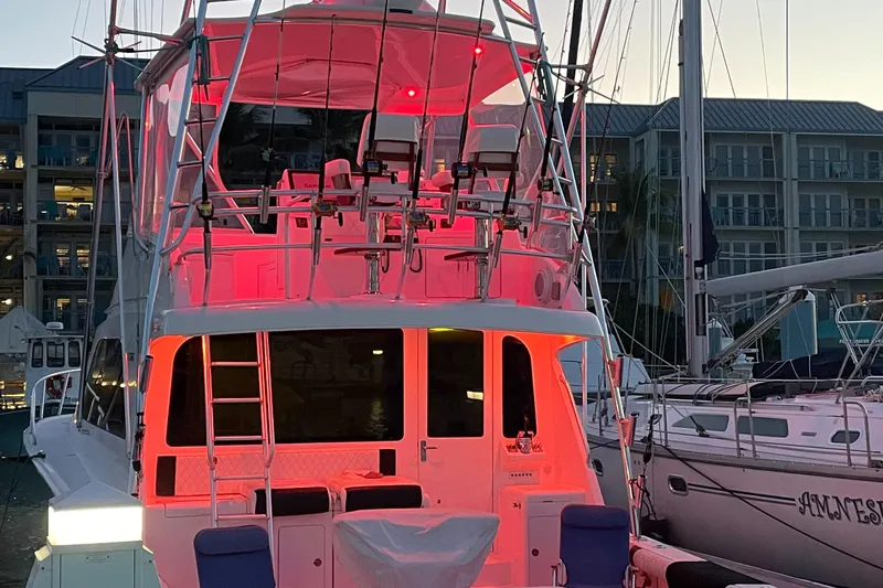  Yacht Photos Pics 2005 Cabo 40 Flybridge yacht with red lighting, docked at marina during evening.