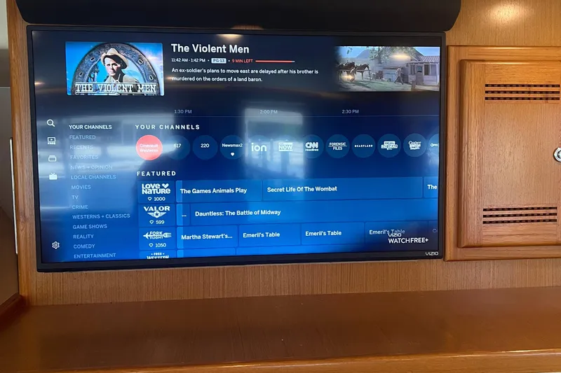  Yacht Photos Pics Flat-screen TV displaying channel guide and movie information on a 2005 Cabo 40 Flybridge.