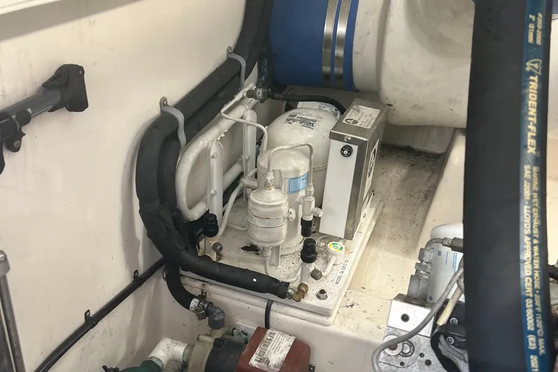  Yacht Photos Pics Engine room of 2005 Cabo 40 Flybridge with mechanical components and hoses.