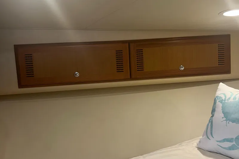  Yacht Photos Pics 2005 Cabo 40 Flybridge interior with wooden cabinets and decorative pillow.