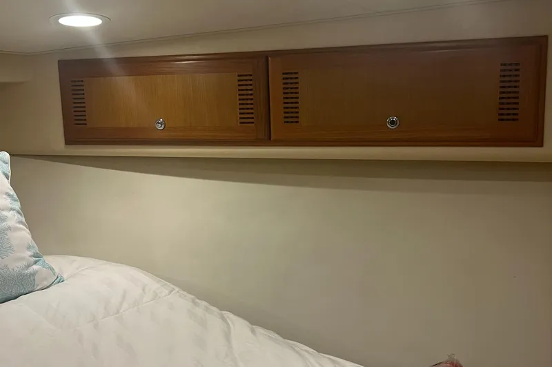  Yacht Photos Pics Interior cabin of 2005 Cabo 40 Flybridge with wooden storage cabinets.