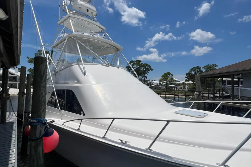  Yacht Photos Pics 2005 Cabo 40 Flybridge yacht docked under a clear blue sky.