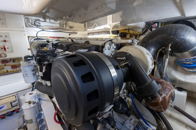  Yacht Photos Pics Engine room of a 2005 Cabo 40 Flybridge boat, showcasing detailed machinery and components.