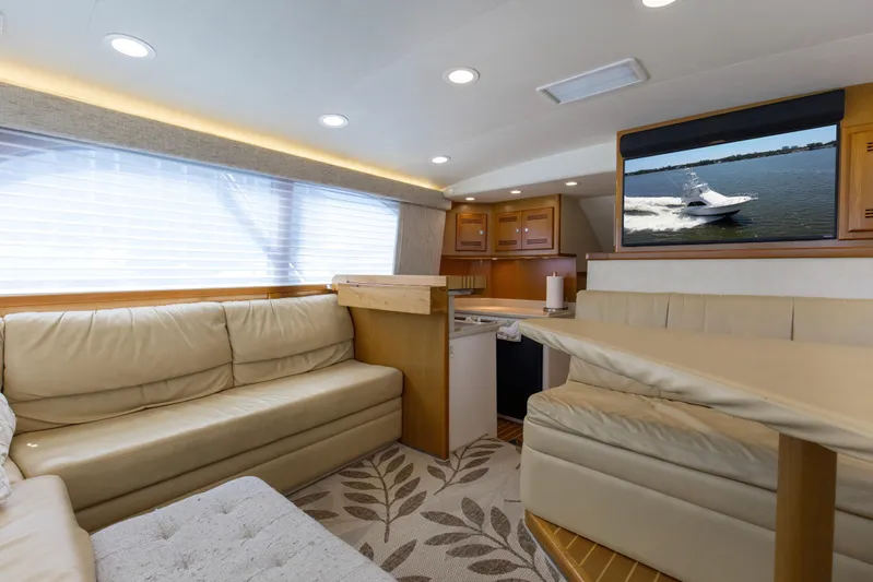  Yacht Photos Pics Luxurious interior of 2005 Cabo 40 Flybridge yacht with beige seating and modern amenities.