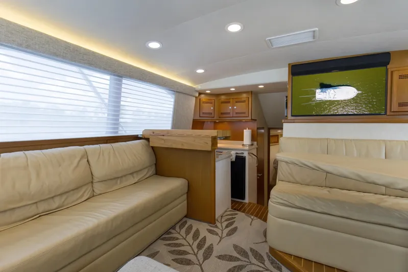  Yacht Photos Pics Luxurious interior of 2005 Cabo 40 Flybridge yacht with plush seating and modern amenities.