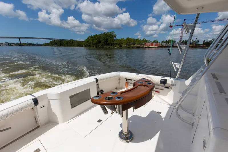  Yacht Photos Pics 2005 Cabo 40 Flybridge yacht deck with fishing rod holders on a sunny day.