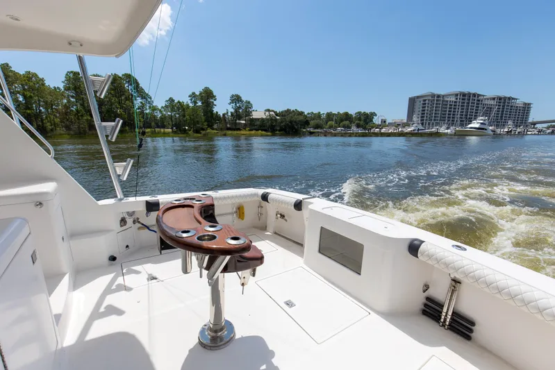  Yacht Photos Pics 2005 Cabo 40 Flybridge yacht cruising on a sunny day, with scenic waterfront view.