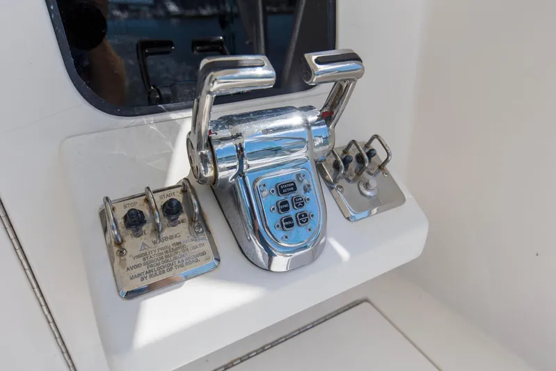  Yacht Photos Pics Control panel of a 2005 Cabo 40 Flybridge yacht with chrome levers and buttons.