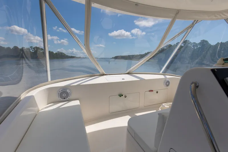  Yacht Photos Pics 2005 Cabo 40 Flybridge interior view with clear skies and scenic waterway.