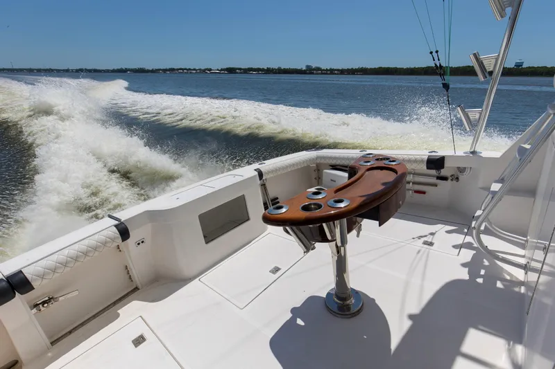  Yacht Photos Pics 2005 Cabo 40 Flybridge boat cruising on open water, featuring a sleek fishing cockpit.