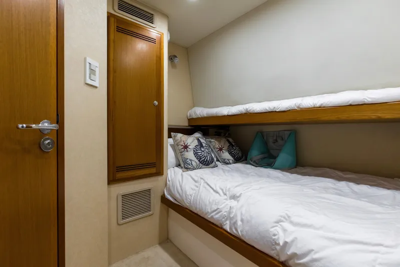  Yacht Photos Pics 2005 Cabo 40 Flybridge cabin with cozy bunk beds and nautical-themed pillows.