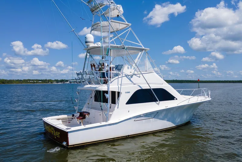  Yacht Photos Pics 2005 Cabo 40 Flybridge yacht on calm waters under a blue sky.
