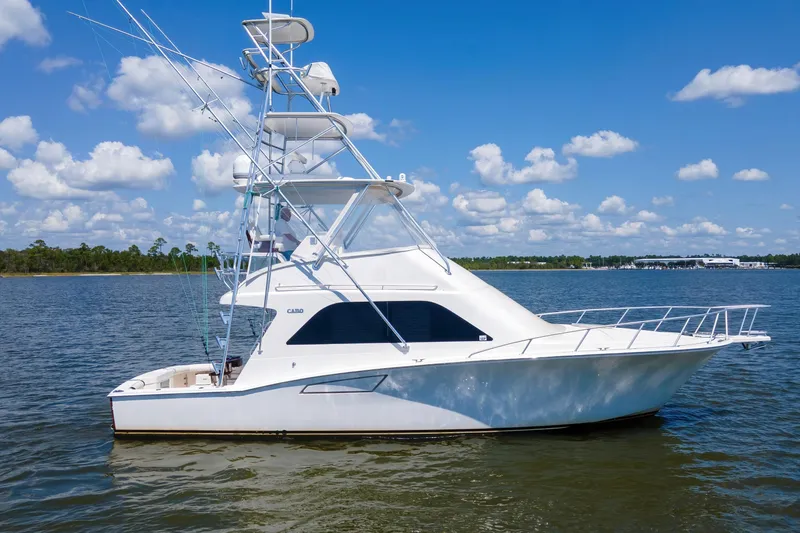  Yacht Photos Pics 2005 Cabo 40 Flybridge yacht on calm water under a blue sky.