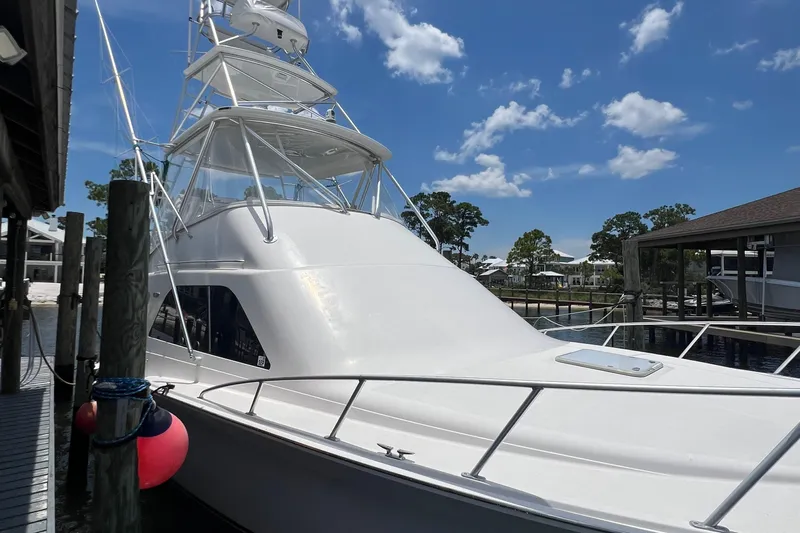  Yacht Photos Pics 2005 Cabo 40 Flybridge yacht docked under a clear blue sky.