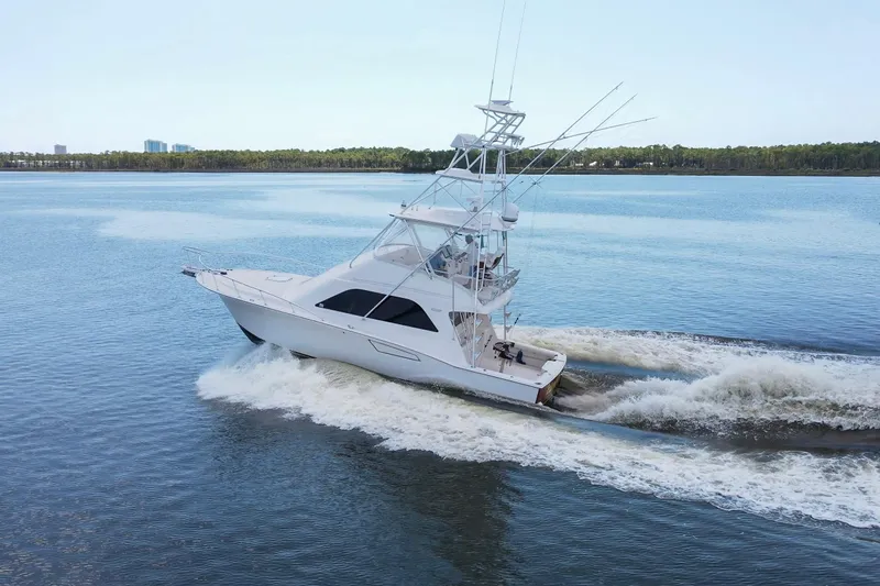  Yacht Photos Pics 2005 Cabo 40 Flybridge yacht cruising on calm waters.