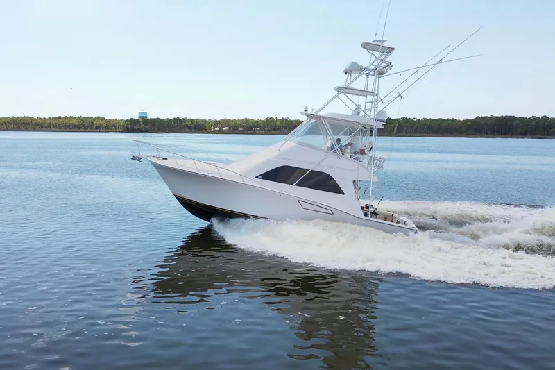  Yacht Photos Pics 2005 Cabo 40 Flybridge yacht cruising on calm waters.