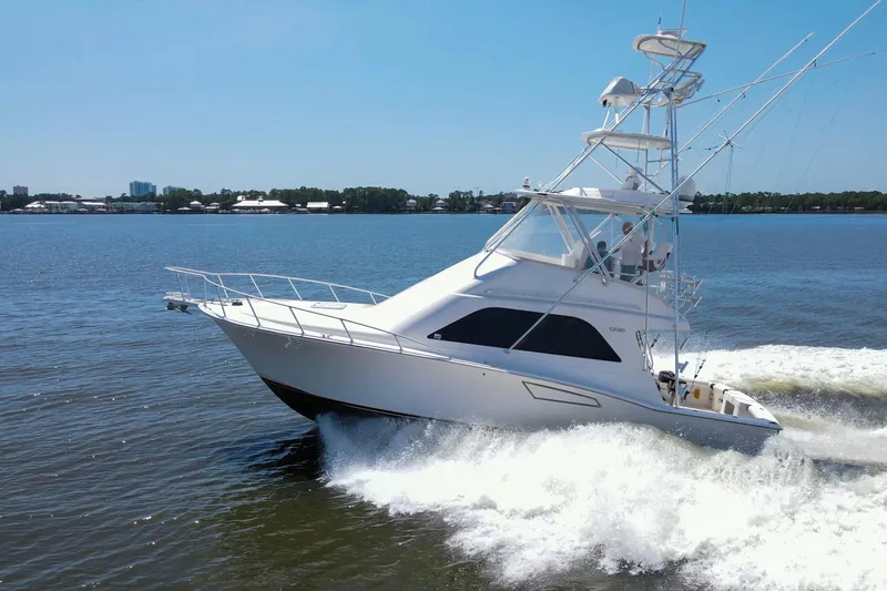  Yacht Photos Pics 2005 Cabo 40 Flybridge yacht cruising on open water under clear blue sky.