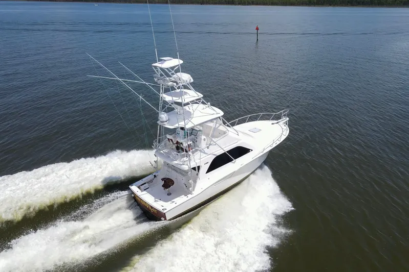  Yacht Photos Pics 2005 Cabo 40 Flybridge yacht cruising on open water, aerial view.