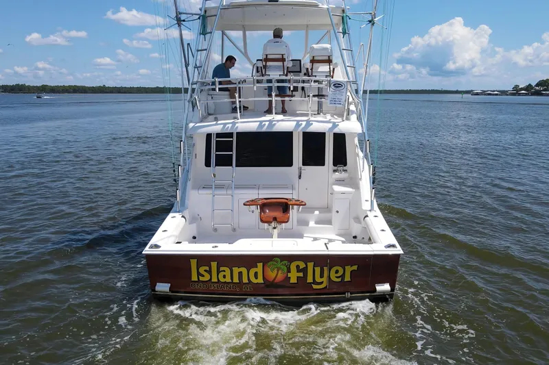  Yacht Photos Pics 2005 Cabo 40 Flybridge boat named "Island Flyer" on water, rear view.