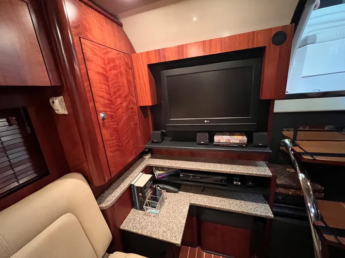  Yacht Photos Pics Luxurious interior of 2009 Monterey 415 SY yacht with TV and wooden cabinetry.
