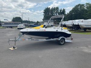 2009 Sea-Doo 150 Speedster 255 on trailer in parking lot, under cloudy sky.