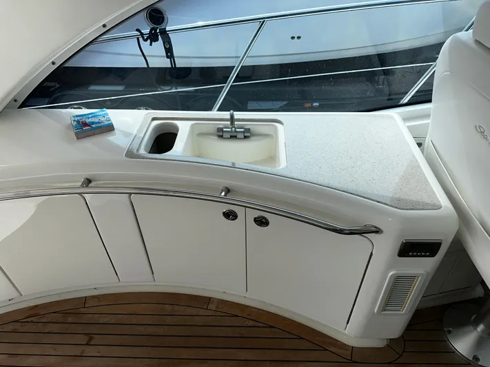 Man O War Yacht Photos Pics 2009 Sea Ray 580 Sundancer yacht kitchenette with sink and countertop, featuring sleek design.