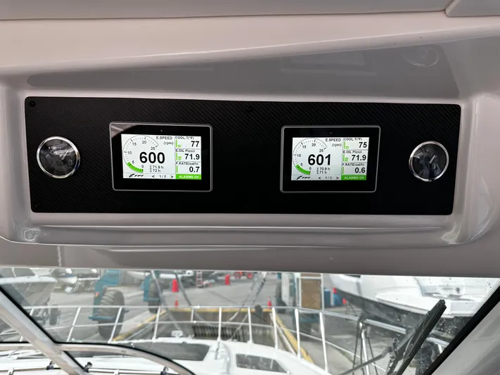 Man O War Yacht Photos Pics Dashboard of 2009 Sea Ray 580 Sundancer with dual digital displays showing engine data.