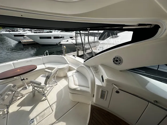 Man O War Yacht Photos Pics 2009 Sea Ray 580 Sundancer yacht interior with seating and table, docked at marina.