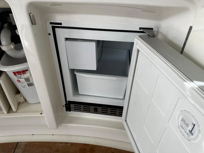 Man O War Yacht Photos Pics Open refrigerator on 2009 Sea Ray 580 Sundancer yacht, showcasing interior storage compartments.