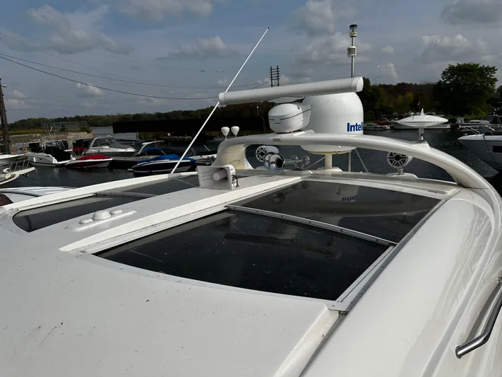 Man O War Yacht Photos Pics 2009 Sea Ray 580 Sundancer yacht with radar equipment, docked at a marina under cloudy skies.