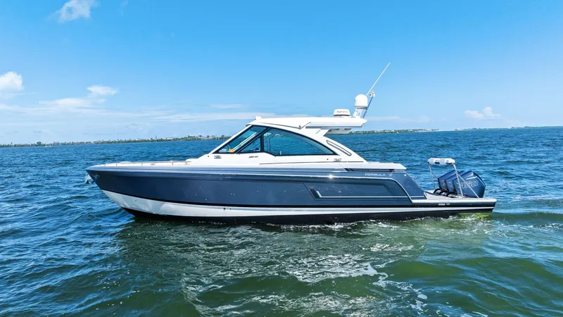  Yacht Photos Pics 2023 Formula 380 Super Sport Crossover OB cruising on open water under clear blue skies.