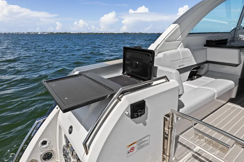  Yacht Photos Pics 2023 Formula 380 Super Sport Crossover OB boat interior with seating and grill, on open water.