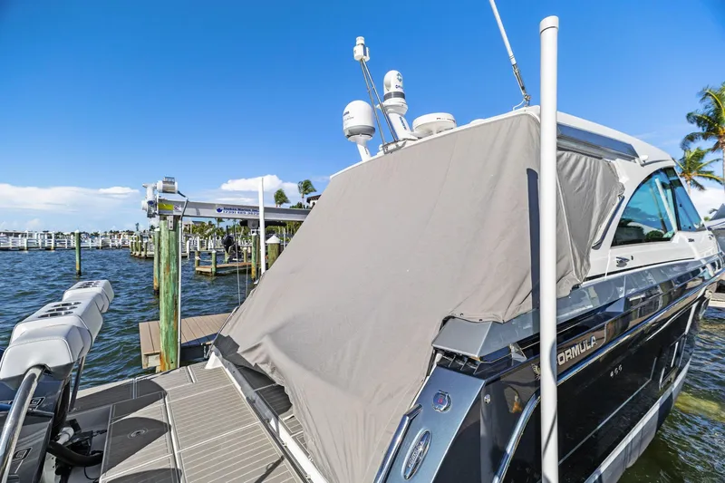  Yacht Photos Pics 2023 Formula 380 Super Sport Crossover OB docked, covered, with clear blue sky background.