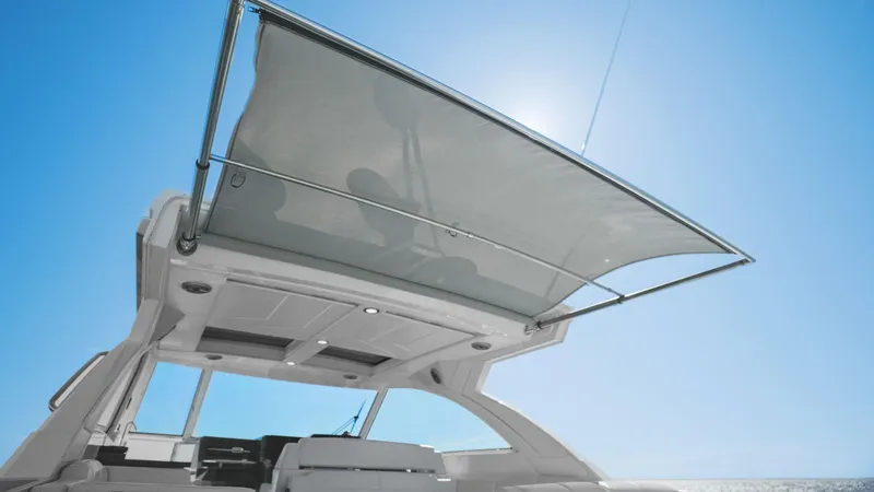  Yacht Photos Pics 2023 Formula 380 Super Sport Crossover OB with sunshade under clear blue sky.